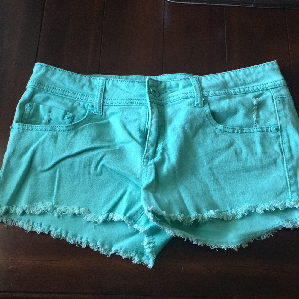 Sea-foam green denim shorts with fringe